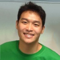 Bob Sim, a student with short brown hair, smiling in front of a white wall.